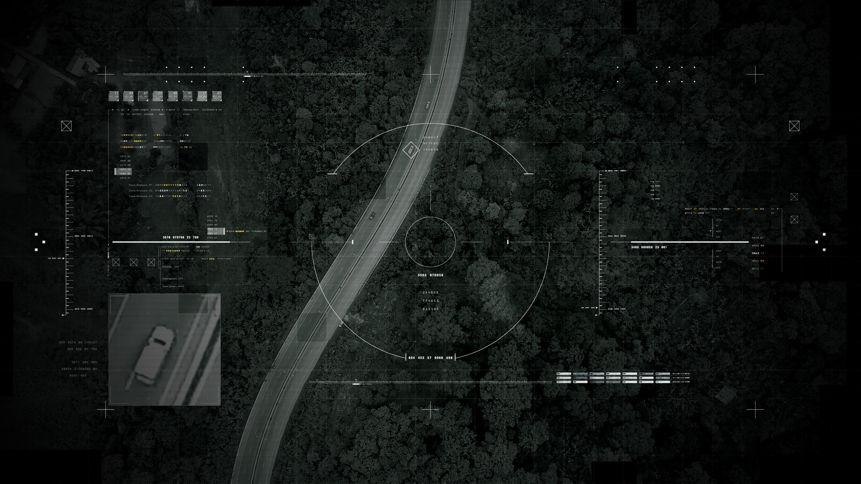 Aerial surveillance view of a road through dense forest overlaid with military targeting HUD graphics, crosshairs and data readouts.